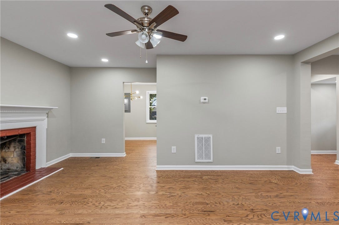 2606 Hawthorne Avenue, Richmond, VA 23222 Hardwood flooring, recessed lighting, ceiling fan, fireplace with a white mantel, and light-toned wall paint