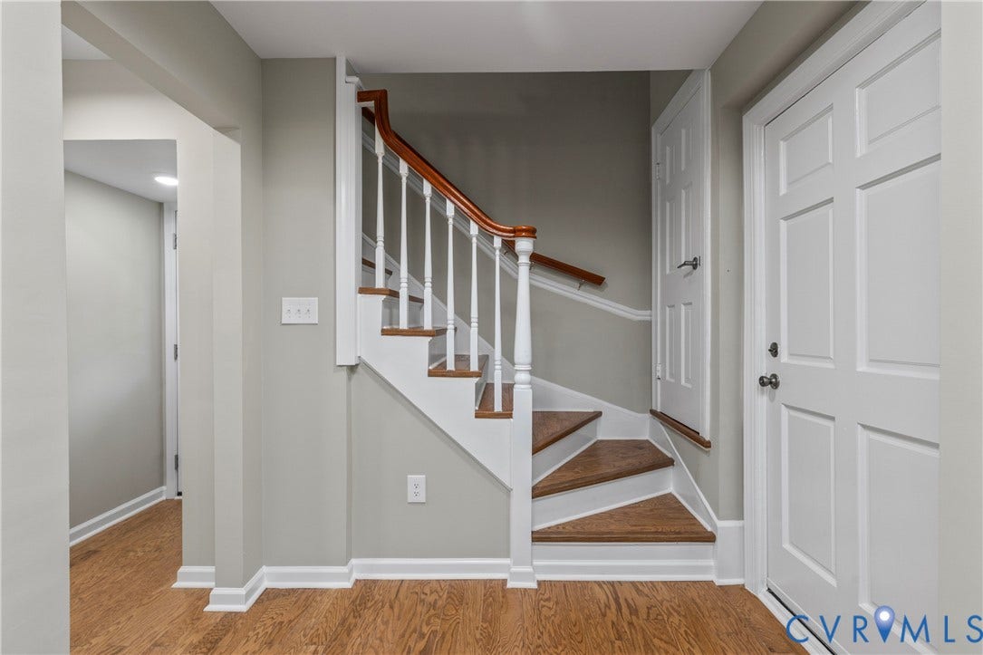 2606 Hawthorne Avenue, Richmond, VA 23222 Hardwood flooring, painted interior walls, white trim, paneled interior doors, and a staircase with wood treads and a wood handrail