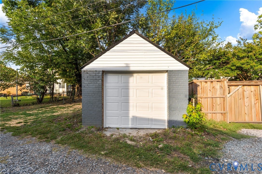 2606 Hawthorne Avenue, Richmond, VA 23222 Detached garage featuring a white panel door, painted brick lower walls, and horizontal white siding on the upper portion