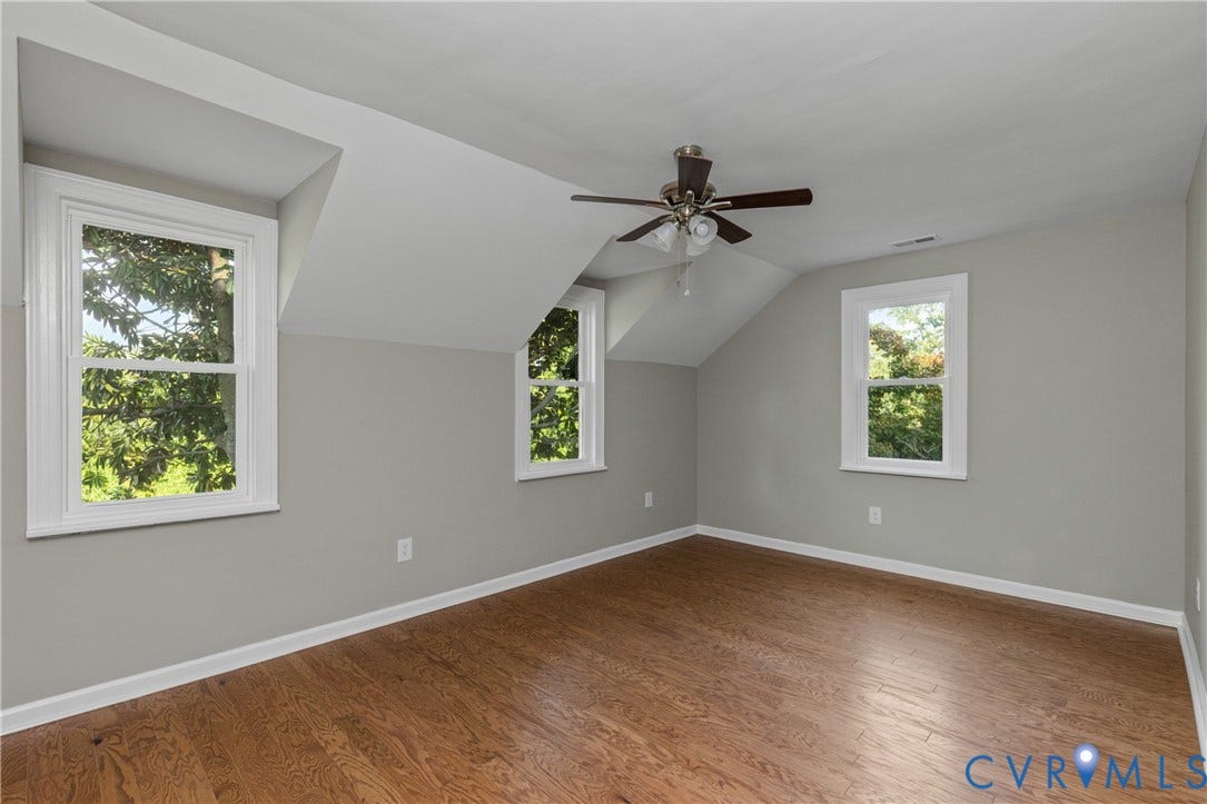 2606 Hawthorne Avenue, Richmond, VA 23222 Hardwood flooring, painted walls, windows with white trim, and a ceiling fan with integrated lighting