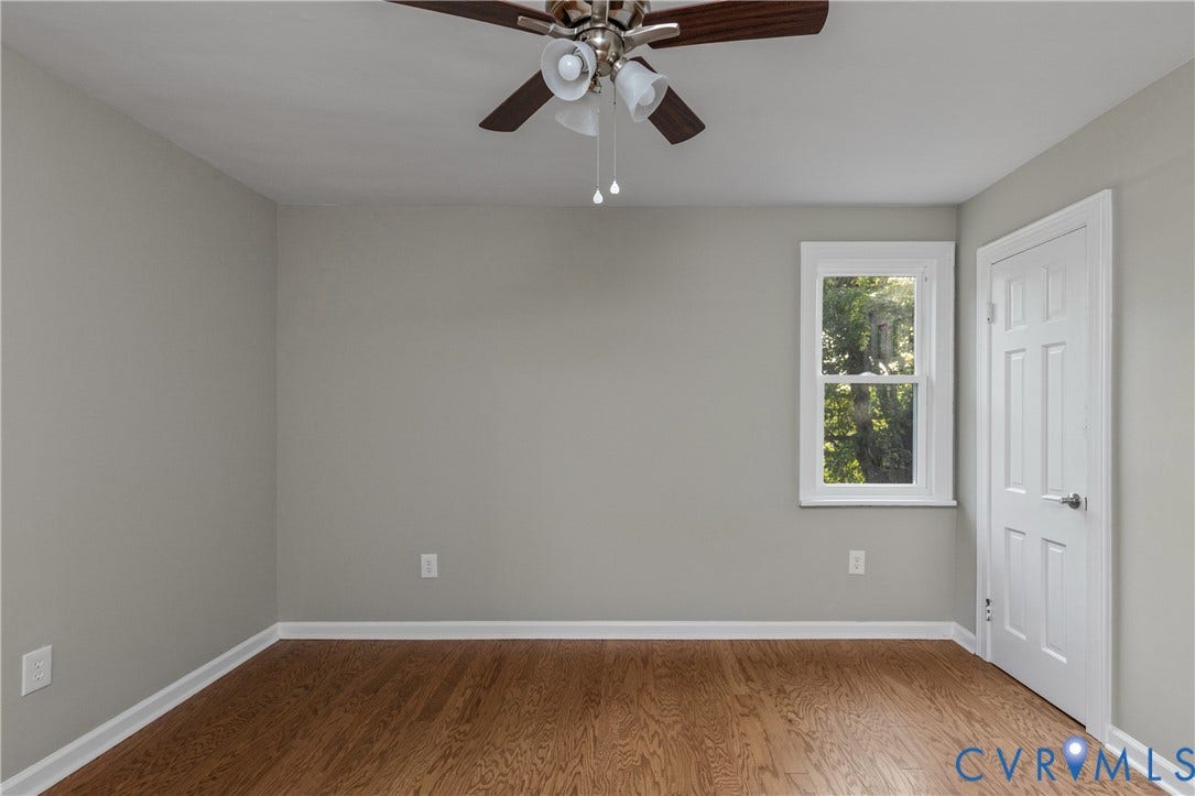 2606 Hawthorne Avenue, Richmond, VA 23222 Wood-finish flooring, white trim, single window, paneled door, and a ceiling fan with integrated lighting