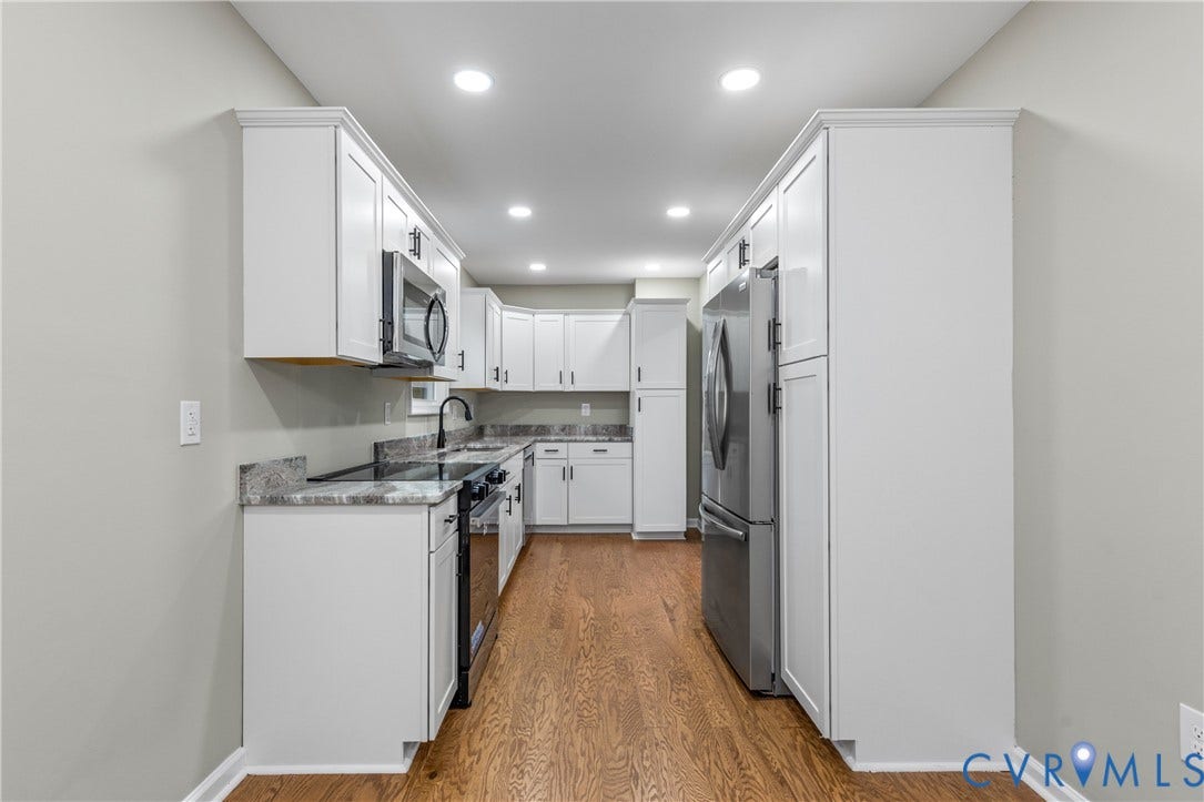 2606 Hawthorne Avenue, Richmond, VA 23222 Galley kitchen featuring white cabinetry, integrated stainless steel appliances, recessed lighting, and wood-finish flooring