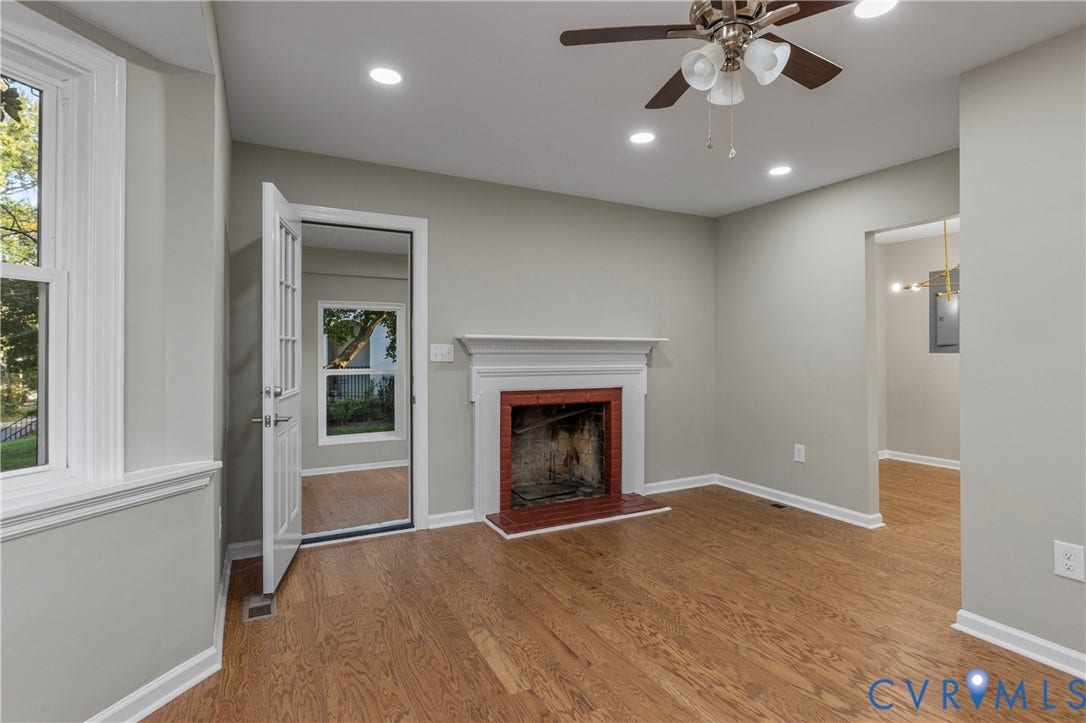 2606 Hawthorne Avenue, Richmond, VA 23222 Hardwood-style flooring, a traditional fireplace with a red brick surround, recessed ceiling lighting, a ceiling fan, and a paneled door