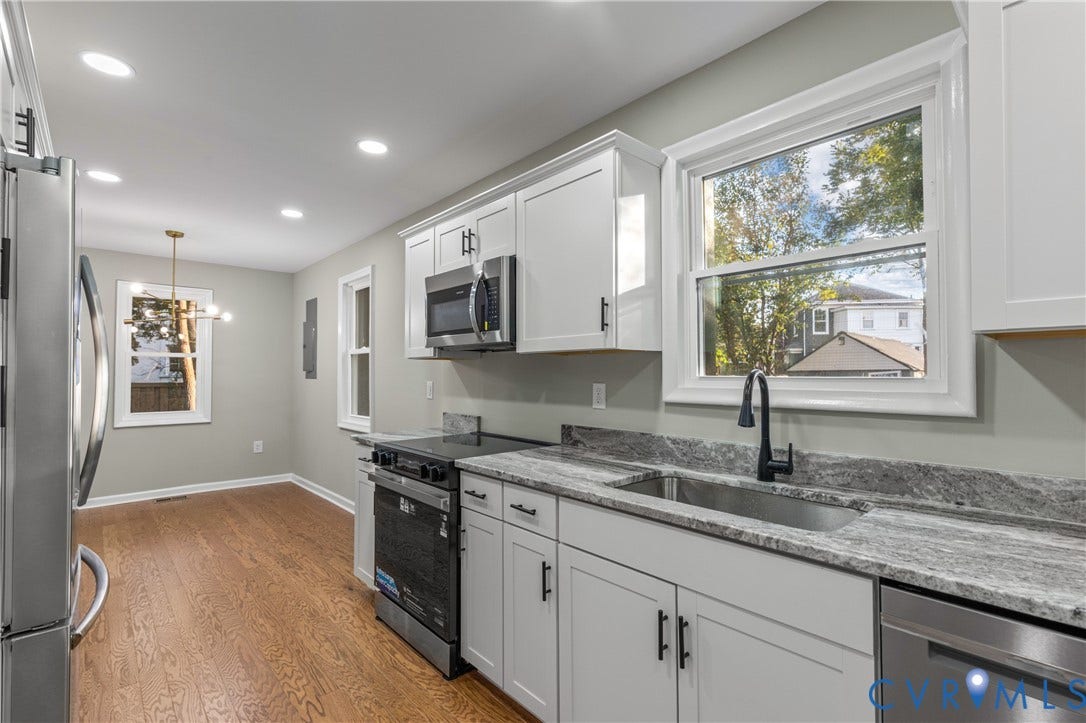 2606 Hawthorne Avenue, Richmond, VA 23222 White shaker cabinetry, stainless steel appliances, granite countertops, and wood-finish flooring