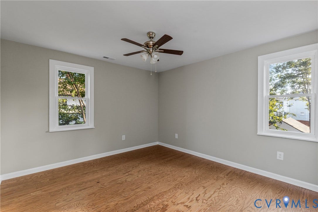 2606 Hawthorne Avenue, Richmond, VA 23222 Wood-finish flooring with light gray walls, white trim, and a ceiling fan with integrated lighting