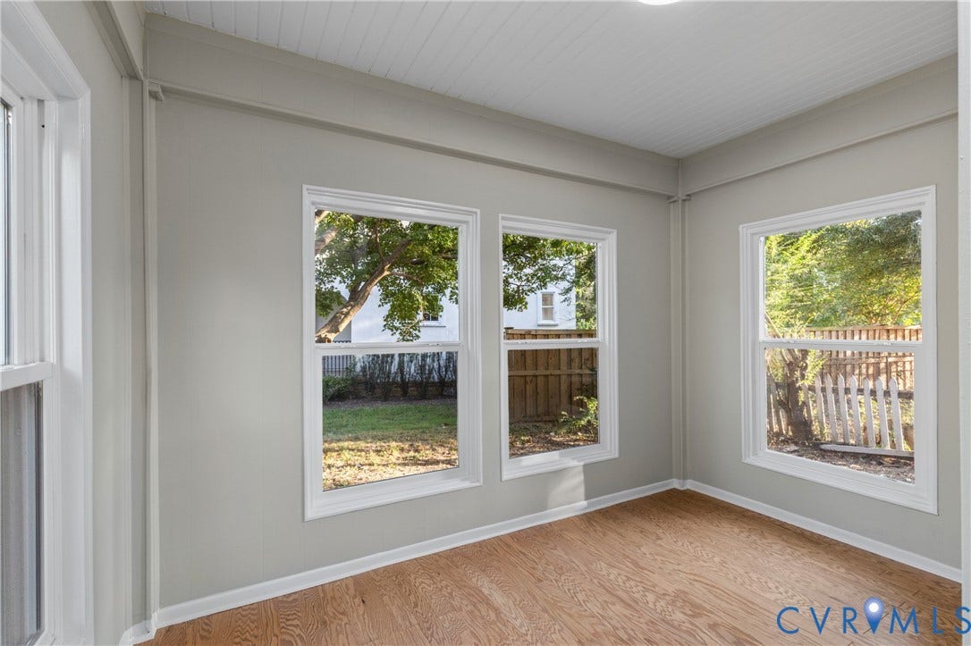 2606 Hawthorne Avenue, Richmond, VA 23222 Multiple windows, wood-finish flooring, light gray walls, white trim, and a paneled ceiling