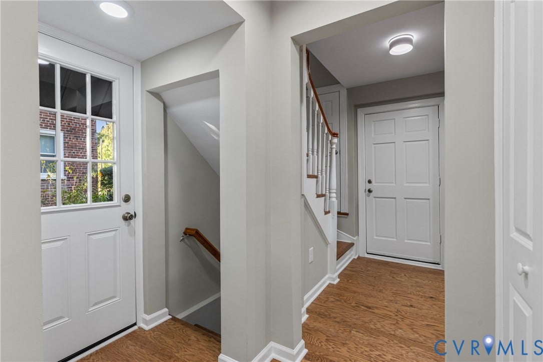 2606 Hawthorne Avenue, Richmond, VA 23222 Wood-finish flooring, white panel doors, recessed ceiling lighting, and a staircase with white balusters and a wood handrail