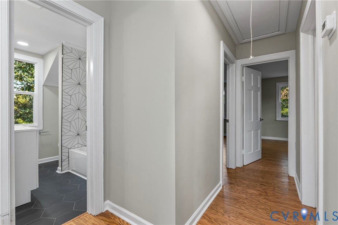 2606 Hawthorne Avenue, Richmond, VA 23222 Hardwood-style flooring in common areas, neutral wall color, white trim, and a white six-panel interior door