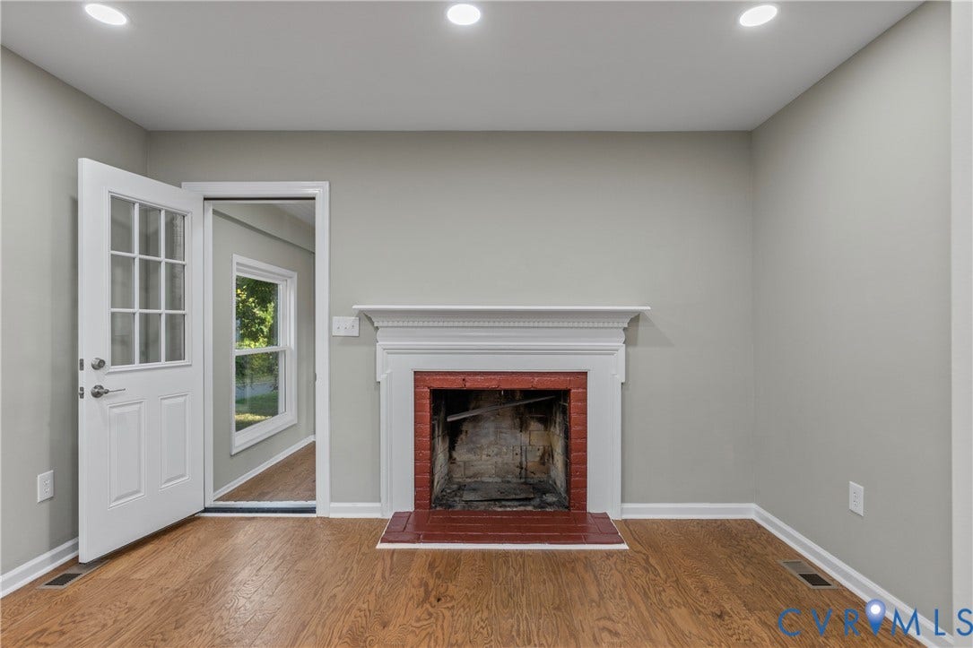 2606 Hawthorne Avenue, Richmond, VA 23222 Hardwood flooring, painted walls, recessed lighting, white door with glass panels, and a brick fireplace