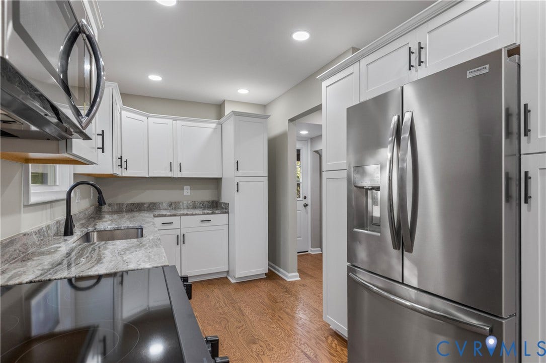 2606 Hawthorne Avenue, Richmond, VA 23222 Kitchen featuring white shaker cabinetry, stainless steel appliances, wood-finish flooring, recessed lighting, and patterned countertops