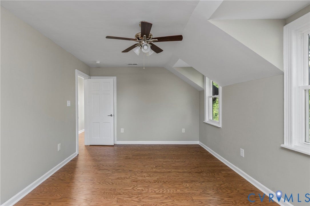 2606 Hawthorne Avenue, Richmond, VA 23222 Hardwood flooring, sloped ceiling, ceiling fan with light fixture, white trim, and multiple windows