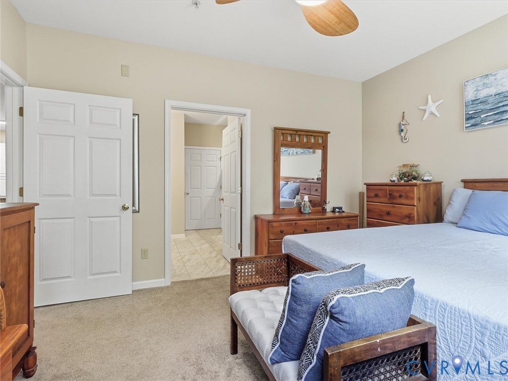 Carpet flooring, ceiling fan, and paneled interior doors