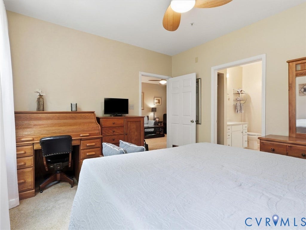Carpeted room with a ceiling fan, recessed lighting, and a white door leading to an adjoining space