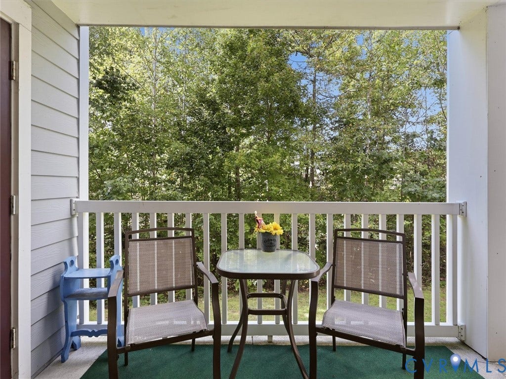 Balcony with white railing and tree scenery