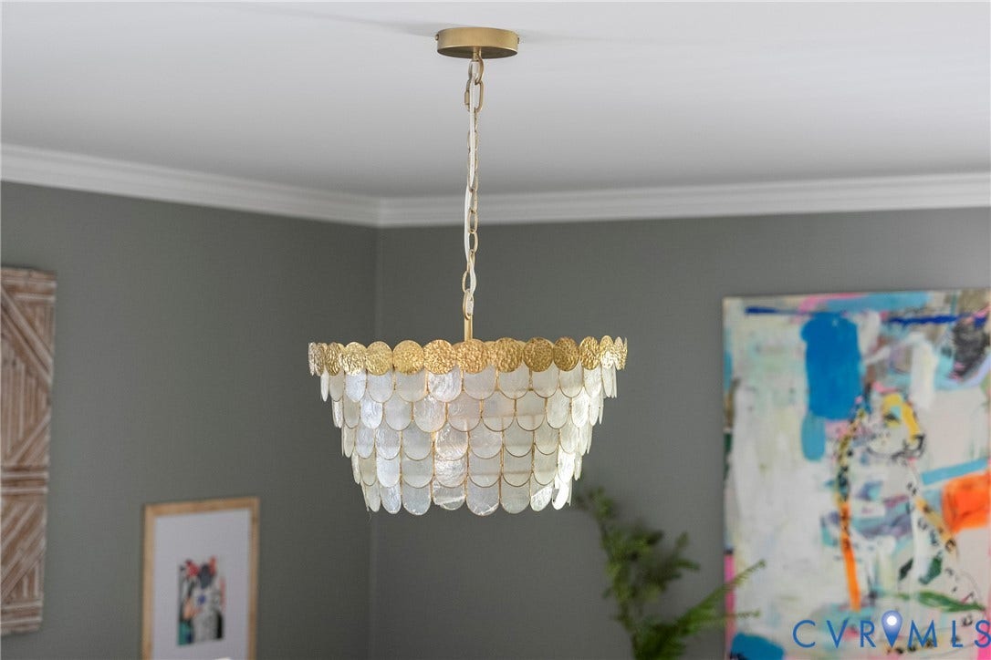 Decorative ceiling fixture with scalloped shell details and gold-tone accents