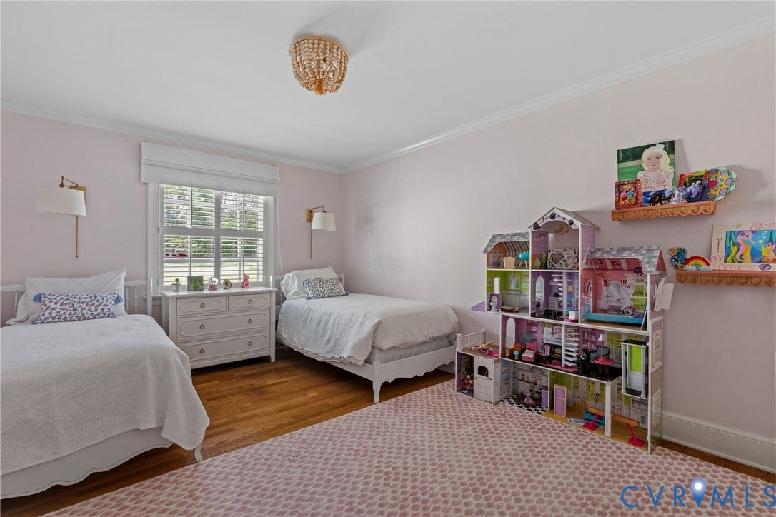 Hardwood flooring, crown molding, a window with plantation shutters, and a beaded chandelier