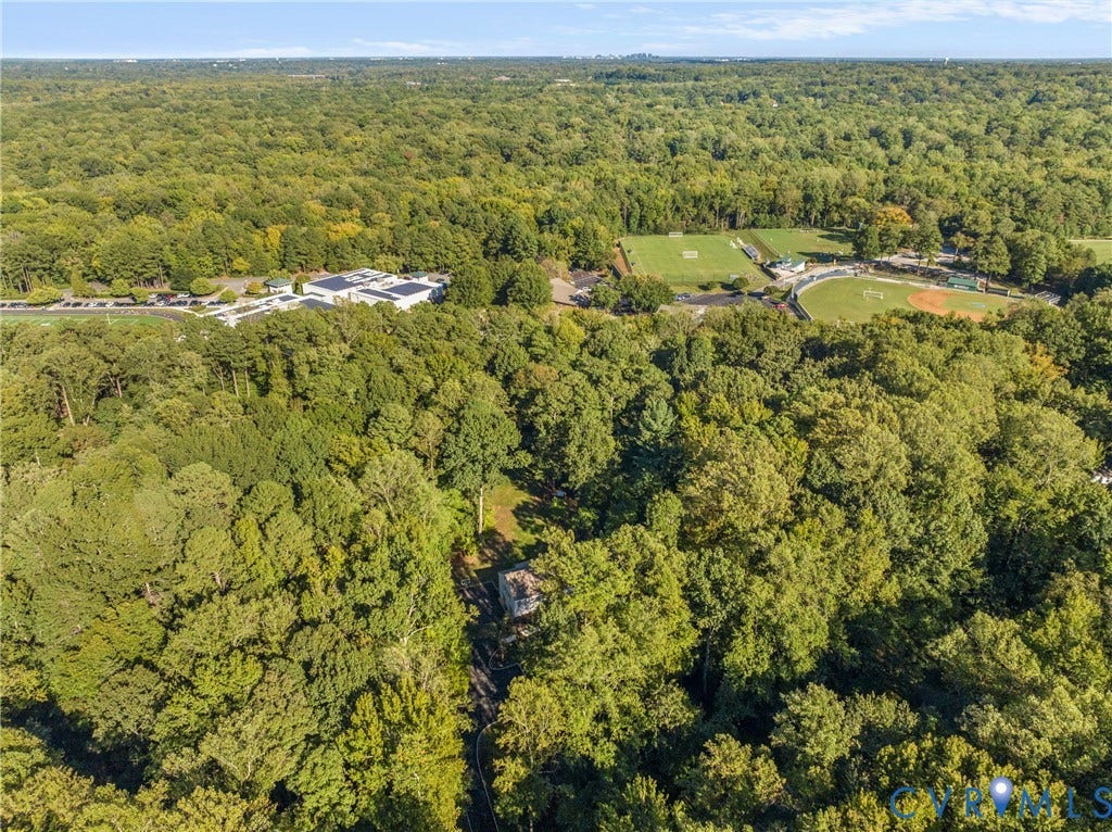 Expansive tree canopy with a single-family residence nestled within