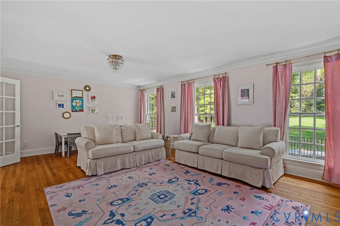 Hardwood flooring, crown molding, French doors, large windows, and a crystal chandelier