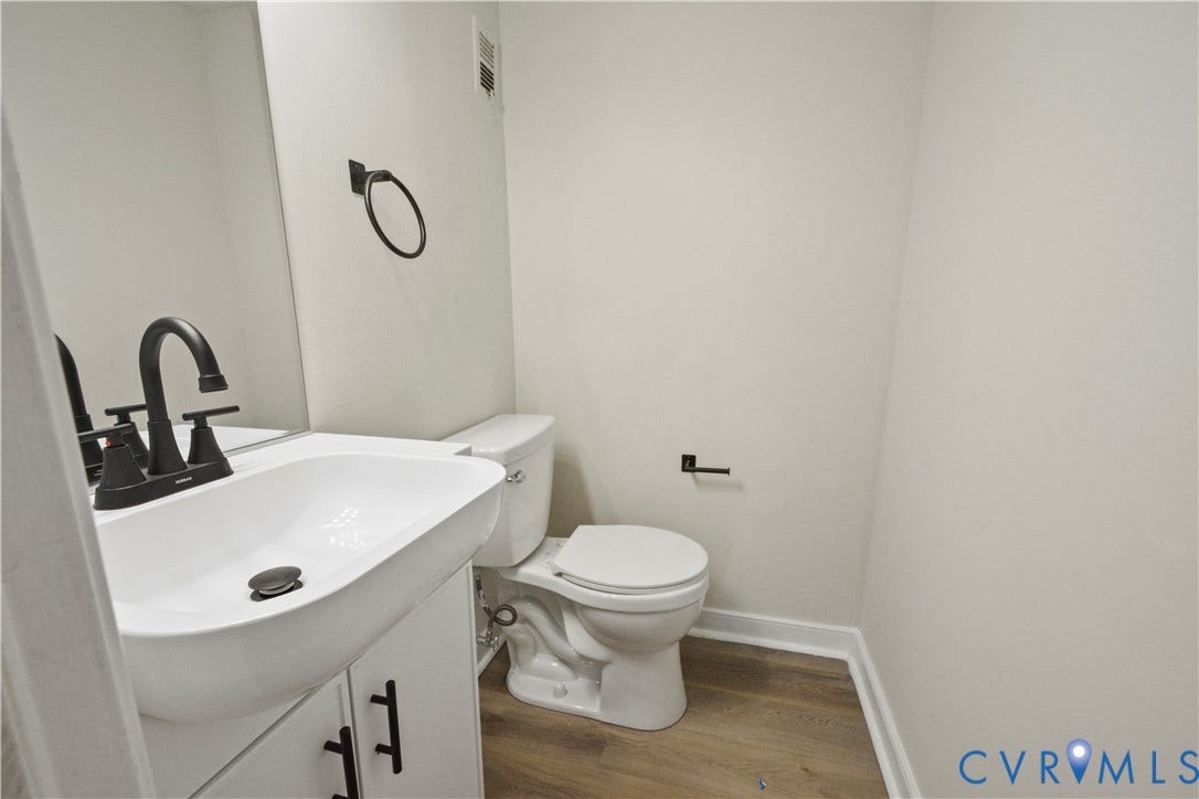White vanity with matte black hardware, a rectangular vessel sink, and a matte black faucet