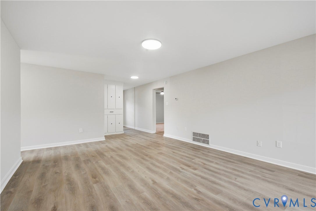 Neutral wall tones with wood-finish flooring