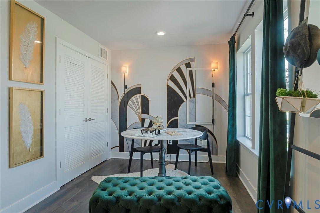 White louvered bi-fold doors, recessed lighting, and dark wood-finish flooring