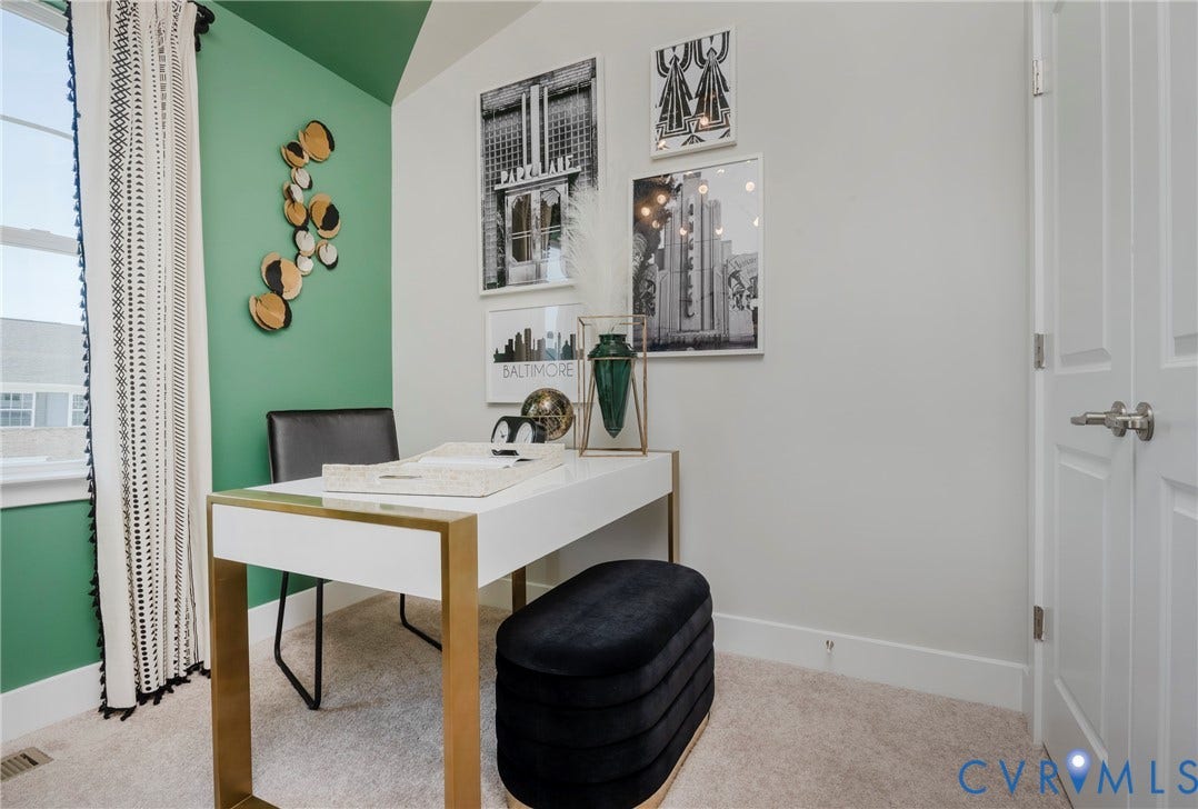 Wall-to-wall carpeting, window with trim, painted accent wall, painted interior door with hardware