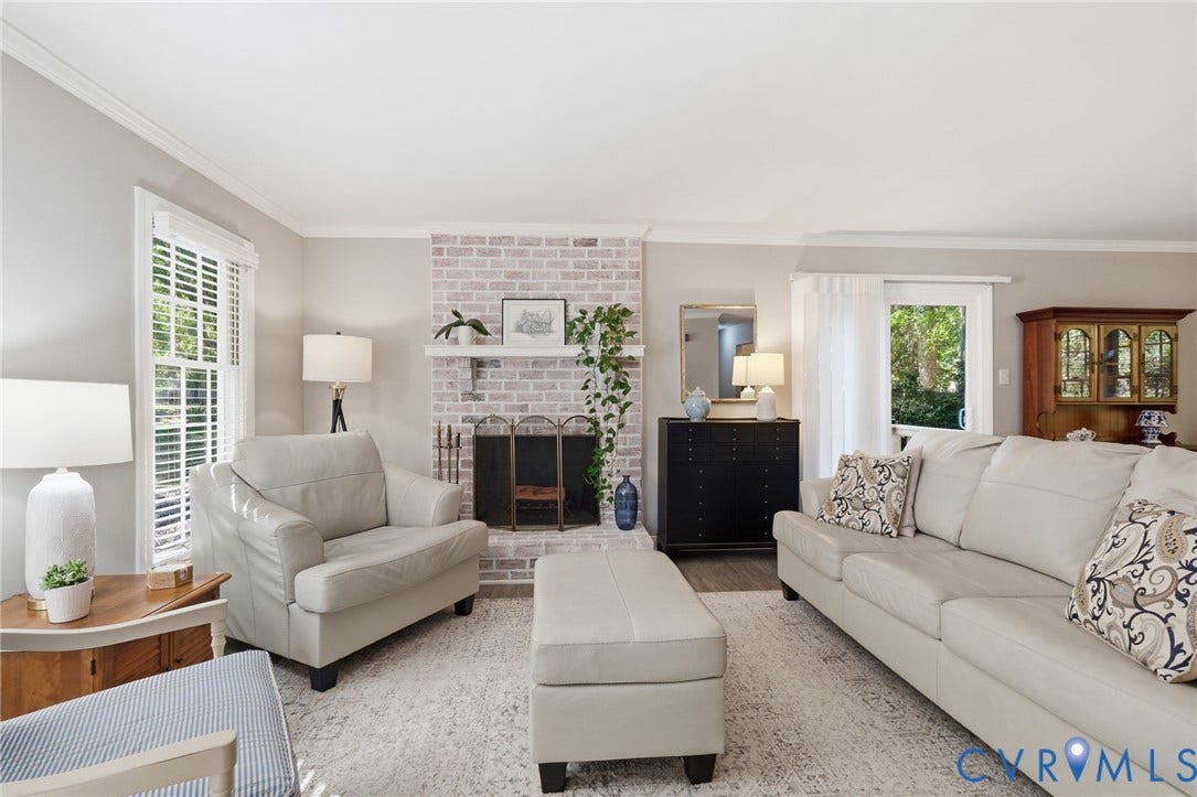 5054 Oakforest Drive, Chesterfield, VA 23832 Bright gathering space featuring a brick fireplace for cozy evenings