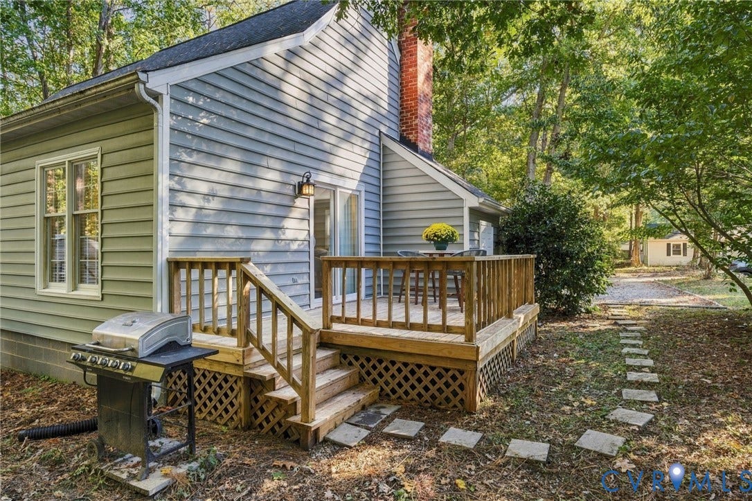 5054 Oakforest Drive, Chesterfield, VA 23832 A peaceful backyard setting with a deck surrounded by mature trees
