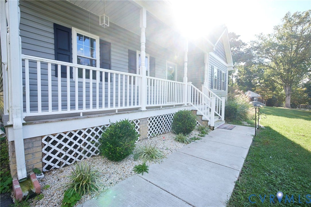 2421 Buena Vista Boulevard, Chester, VA 23831 Gray siding exterior with white porch railings, accent shutters, and a concrete walkway