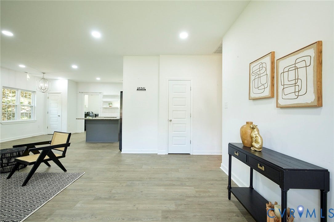 2421 Buena Vista Boulevard, Chester, VA 23831 Expansive open-concept living area with wood-finish flooring, recessed lighting, white walls, and a visible kitchen island
