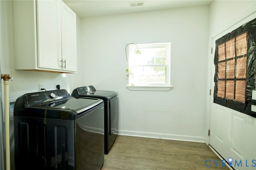 2421 Buena Vista Boulevard, Chester, VA 23831 White upper cabinetry with brushed nickel hardware, wood-finish flooring, and a single window