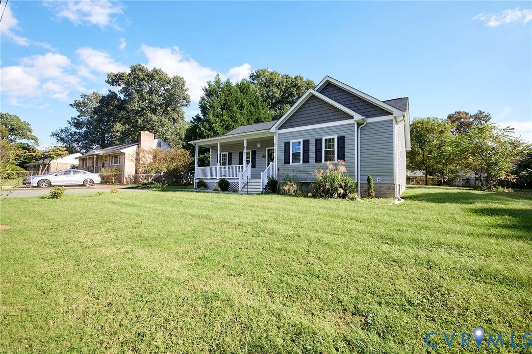 2421 Buena Vista Boulevard, Chester, VA 23831 Light gray siding exterior with dark gray shingles, white-railed front porch, black window shutters, and a green lawn