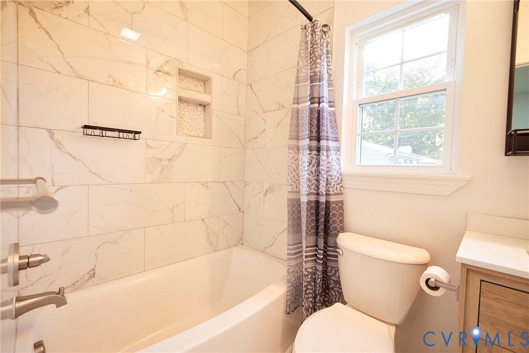 2421 Buena Vista Boulevard, Chester, VA 23831 Bathtub with tile surround, built-in shower niche with mosaic tile, and brushed nickel fixtures