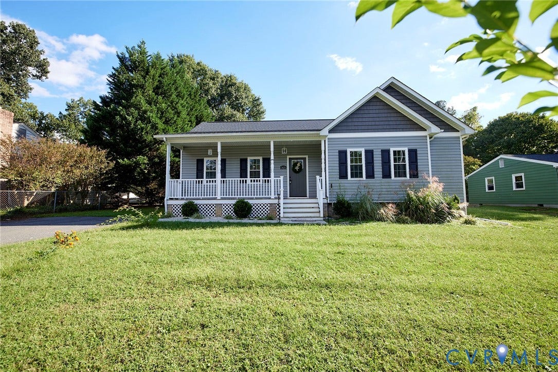 2421 Buena Vista Boulevard, Chester, VA 23831 Light gray siding exterior with dark blue shutters, covered front porch, white porch railing, and a detached green outbuilding