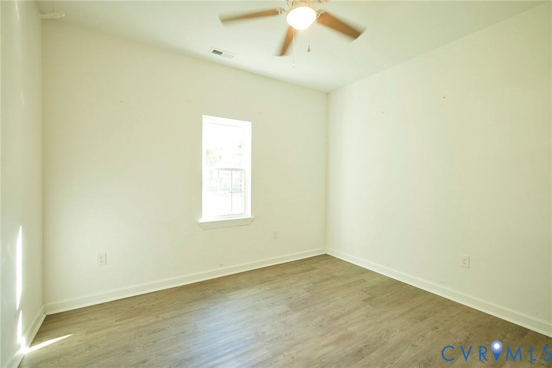 2421 Buena Vista Boulevard, Chester, VA 23831 Room featuring wood-finish flooring, a ceiling fan with integrated lighting, a window, and white trim