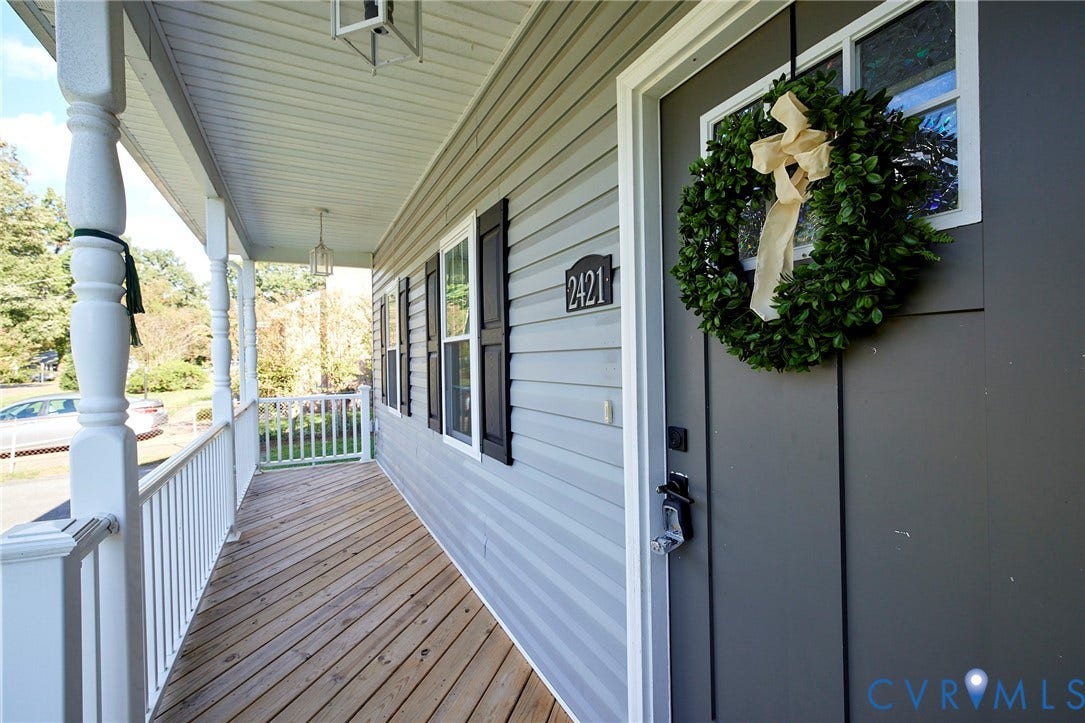 2421 Buena Vista Boulevard, Chester, VA 23831 Covered front porch with wood-finish flooring, white railing, and decorative balusters