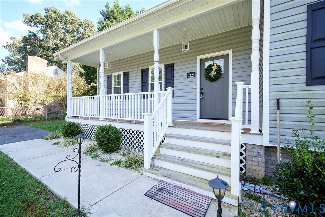 2421 Buena Vista Boulevard, Chester, VA 23831 Covered front porch with white railings, grey siding, and dark shutters