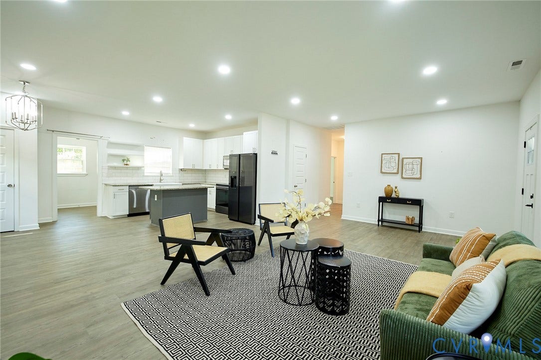 2421 Buena Vista Boulevard, Chester, VA 23831 Open-concept living space with recessed lighting, wood-finish flooring, and a kitchen featuring white cabinetry, a center island, and stainless steel appliances