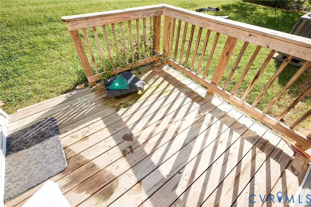 2421 Buena Vista Boulevard, Chester, VA 23831 Wood deck with a natural finish, featuring a wood railing and a grassy area beyond