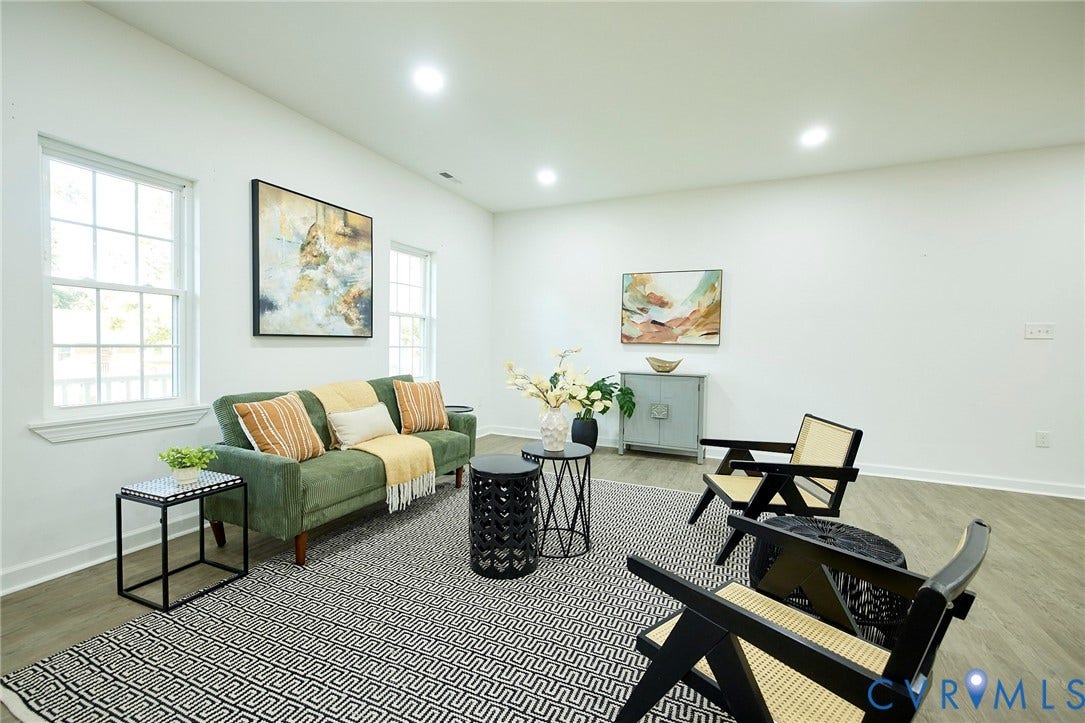 2421 Buena Vista Boulevard, Chester, VA 23831 Bright, light-filled living space featuring recessed ceiling lighting, large gridded windows with natural light exposure, wood-finish flooring, and neutral wall finishes