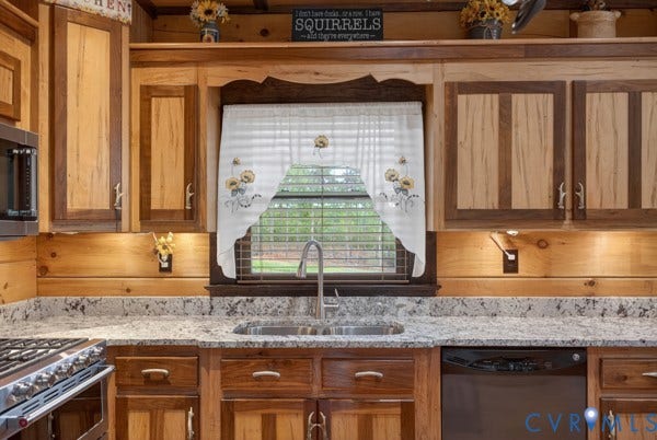 Stained wood cabinetry, granite-finish countertops, undermount stainless steel sink, stainless steel faucet, and dishwasher