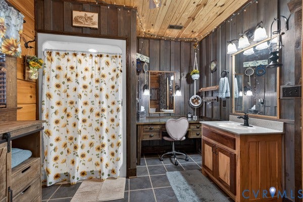 Wood walls and ceiling, tiled flooring, wood vanity