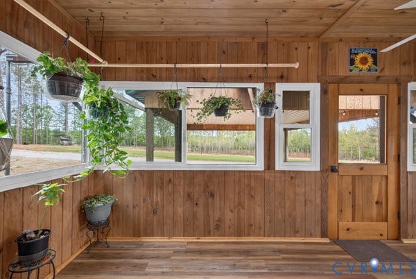Enclosed porched, Wood walls and ceiling, wood-finish flooring, and white-framed windows