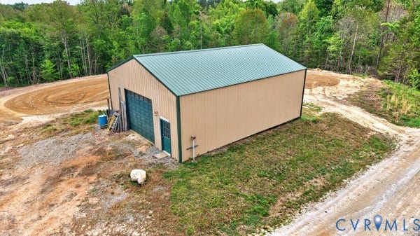 SHOP: Metal-clad building with a green corrugated roof