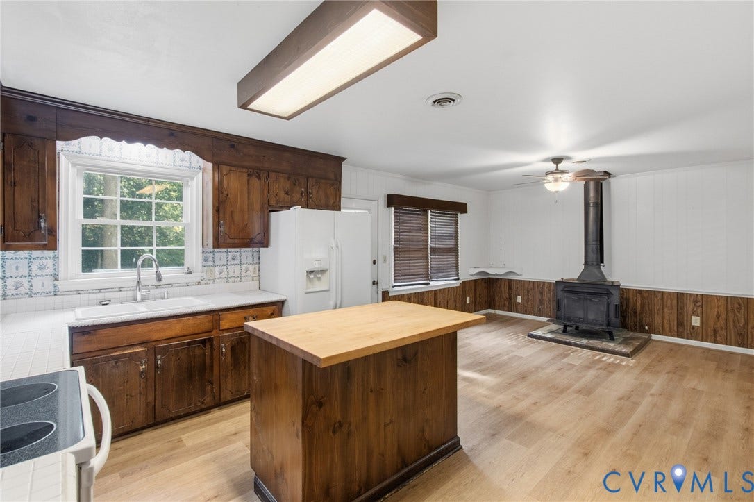 7847 Beaver Drive, All Others Area 20, Gloucester, VA 23061 Wood-finish flooring, wood-paneled walls, a wood-burning stove, and wood cabinetry characterize this space