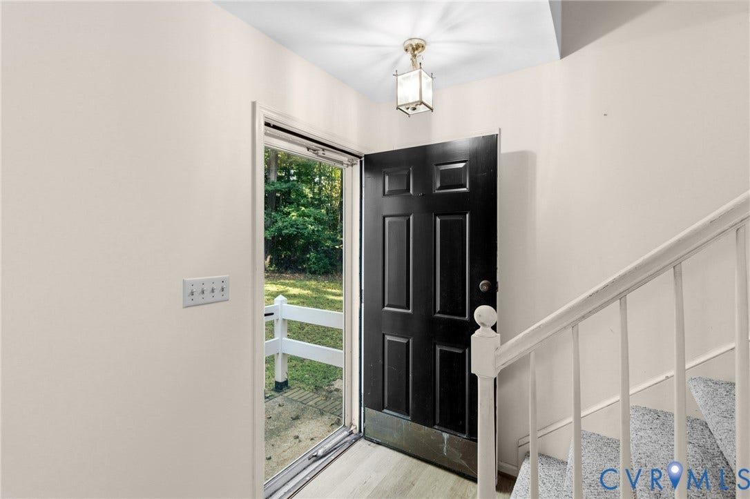 7847 Beaver Drive, All Others Area 20, Gloucester, VA 23061 Panel door entry with a storm door, wood-finish flooring, and a stairway with carpeted treads
