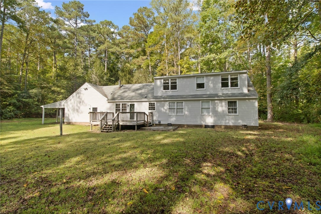 7847 Beaver Drive, All Others Area 20, Gloucester, VA 23061 Rear exterior showcasing a wood deck, white siding, multiple windows, and a covered side entrance