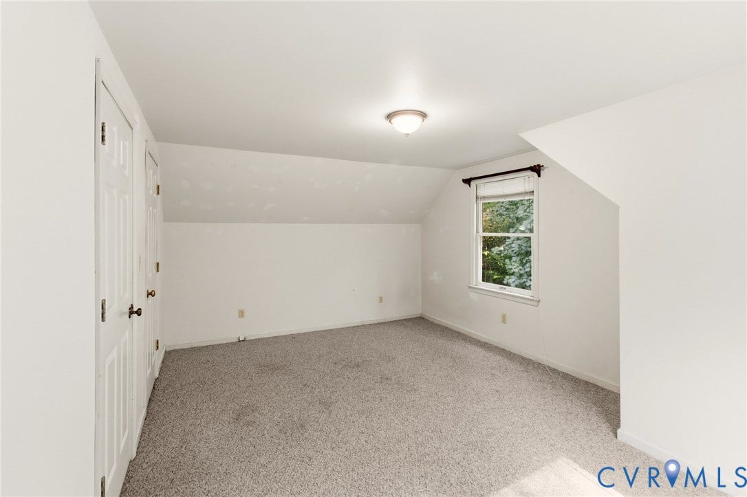 7847 Beaver Drive, All Others Area 20, Gloucester, VA 23061 Neutral tone carpet flooring, built-in storage closets with paneled doors, natural light window, sloped ceiling, and flush-mount ceiling light fixture
