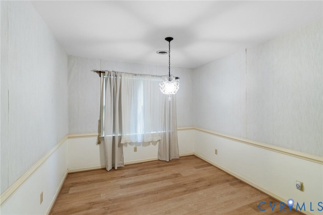 7847 Beaver Drive, All Others Area 20, Gloucester, VA 23061 Wood-finish flooring, white walls with textured upper half, decorative chandelier, and window with natural light