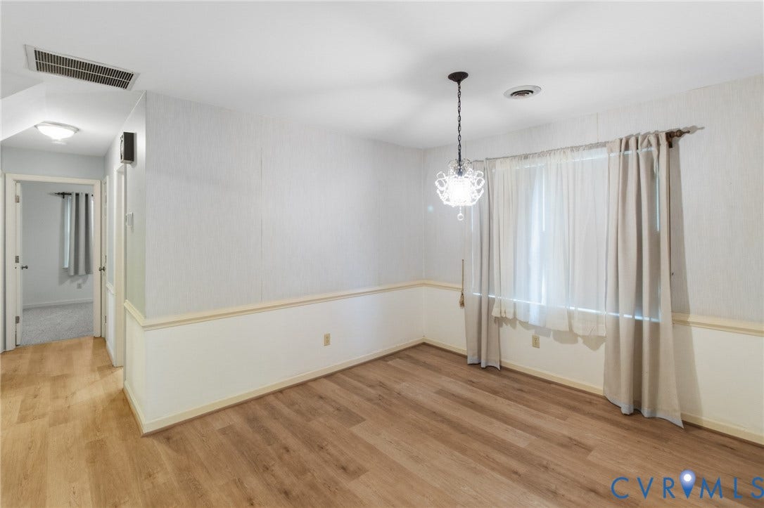 7847 Beaver Drive, All Others Area 20, Gloucester, VA 23061 Wood-finish flooring, wainscoting, and a decorative chandelier